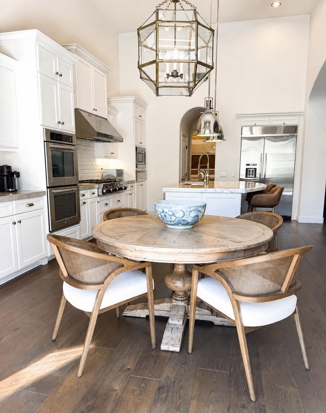 Breakfast nook with round wood table and brass lantern at The Nineteenth