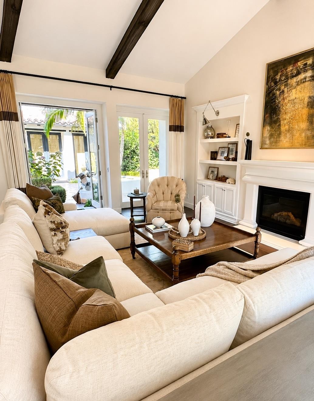 Living room with cream sectional and vaulted beamed ceiling at The Nineteenth