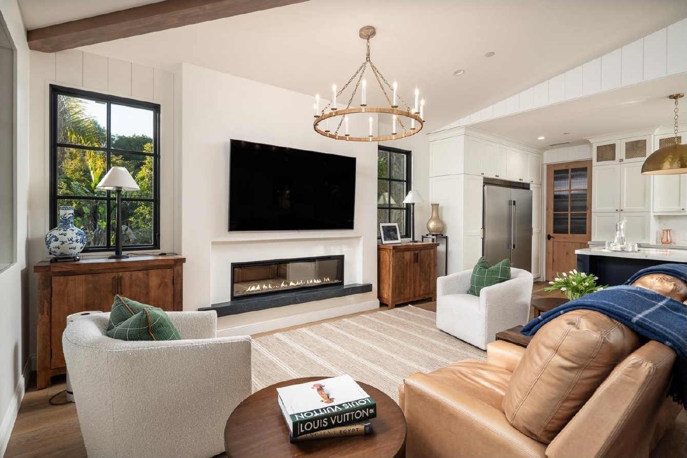 Guest house living room with linear fireplace and leather chairs
