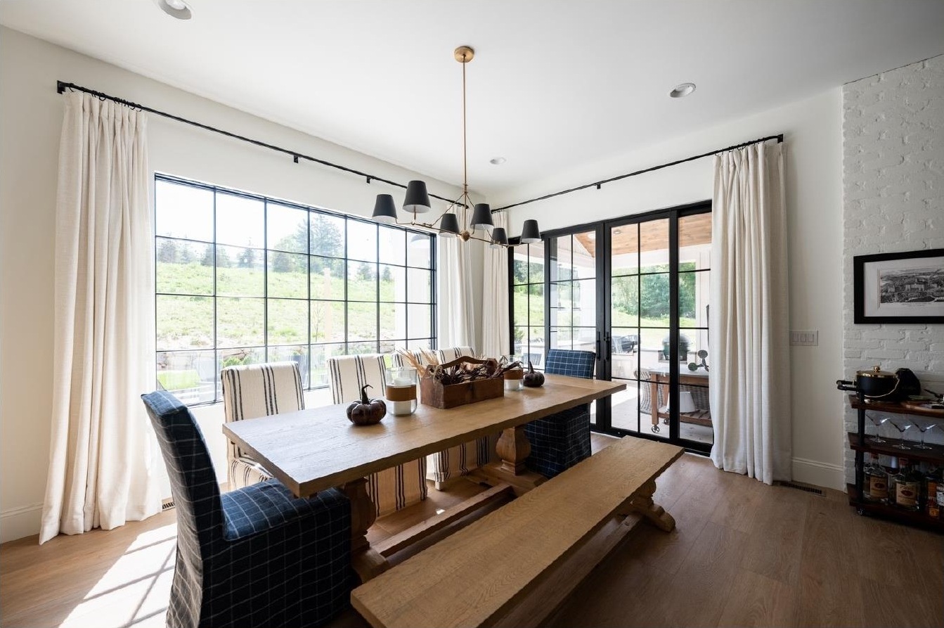 Dining room with trestle table and floor-to-ceiling windows