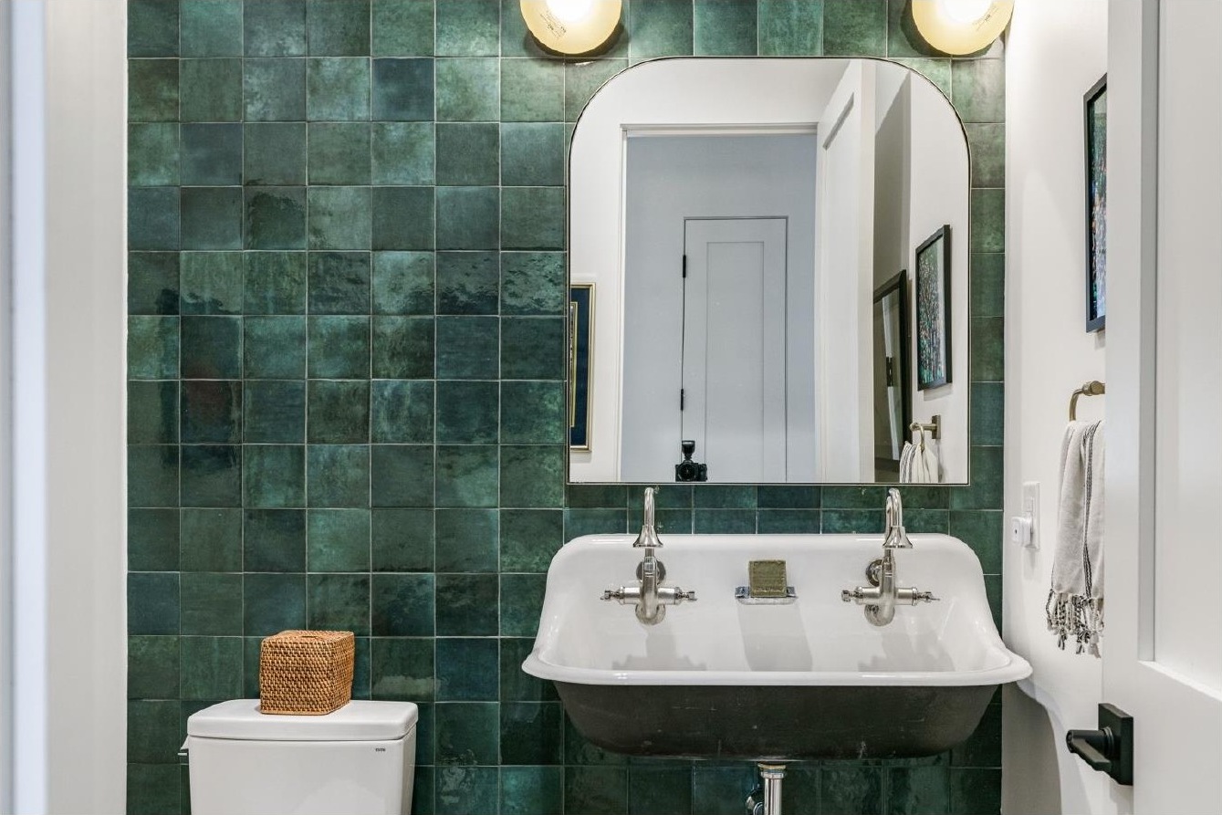 Powder room with green zellige tile and trough sink